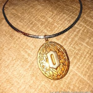 Victorian Style Gold tone locket on bone Golden chain.
